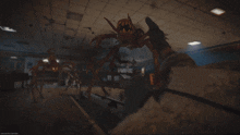 a person is holding a gun in a room with a spider in the background