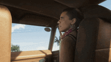 a woman in a car looking out the window