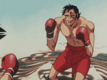 a man in red shorts is boxing another man with black hair