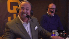 two men wearing headphones are watching a game between the s. bogarets and the senzatella