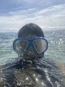 a person wearing a blue scuba diving mask