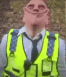 a man wearing a yellow vest and tie with a smiley face on his face .