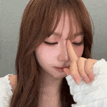 a woman covering her nose with her hand