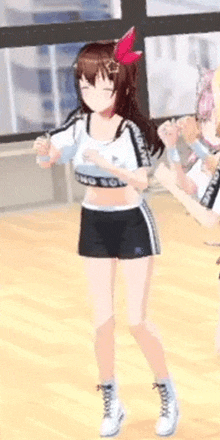 a girl in a crop top and shorts is standing on a wooden floor .