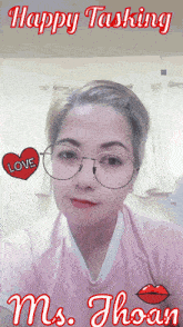 a woman wearing glasses and a pink shirt that says happy tasking ms. thoan