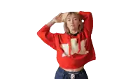 a woman is wearing a red sweater with a white star on it