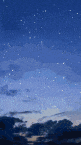 a starry night sky with a few clouds in it