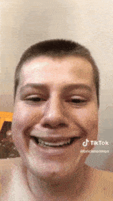 a man with braces on his teeth is smiling and has a tiktok account