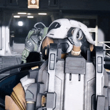 a man in a futuristic suit with the letter e on the back of his helmet