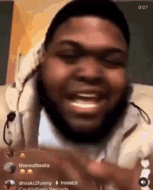 a man with dreadlocks is making a funny face while talking to someone