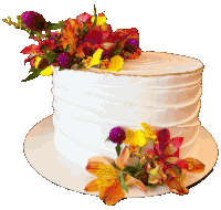 a white cake with flowers on top is on a white plate