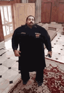 a man standing in a room with a name tag that says ' muhammad ali ' on it