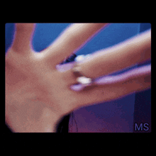 a close up of a woman 's hand with the letters ms on the bottom right