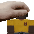 a person 's hand is reaching out towards a yellow shirt .