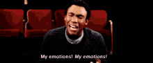 a man is sitting in a theater with his eyes closed and says my emotions my emotions !