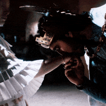 a man with a crown on his head kissing a woman 's hand