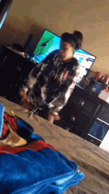 a girl is standing in front of a television in a room