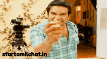 a man is pointing at the camera with the website starttamilchat.in in the foreground