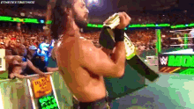a pixelated image of a wrestler holding a bottle of beer in front of a crowd