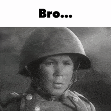 a black and white photo of a young boy wearing a helmet with the words bro written above him