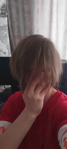 a person covering their face with their hand