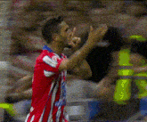 a soccer player wearing a red and white jersey with the number 10 on the back