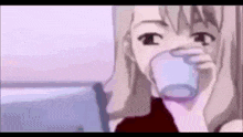 a girl is drinking a glass of milk from a cup .