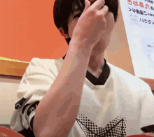 a person wearing a white shirt with the letter r on the arm