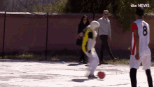 a soccer player with the number 8 on his jersey is kicking the ball