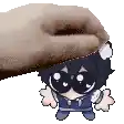 a hand is putting a stuffed animal on top of a cartoon character 's head .