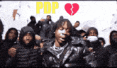 a man in a black jacket stands in front of a group of men with the word pdp written above him