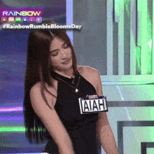 a woman in a black tank top has a name tag that says aiah