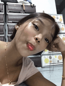 a girl with red lipstick is taking a picture of herself