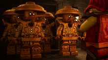 a group of lego figures are standing next to each other with one wearing a red cape that says ninjago