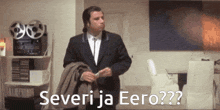 a man in a suit is standing in a room with the words severi ja eero