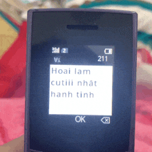 a cell phone with the number 211 on the screen