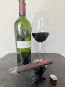 a bottle of vergelligen wine sits next to a glass of wine