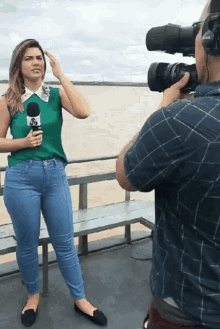 a woman holding a microphone with the letter s on it