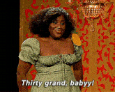 a woman in a green dress is saying thirty grand baby