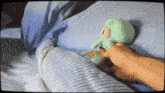 a person is holding a stuffed animal that looks like squidward from spongebob squarepants