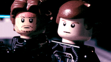 two lego figures are standing next to each other with one having a beard