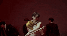 a man is holding a white flag in front of a group of people .