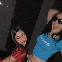 two women are posing for a picture and one of them is wearing a shirt that says ' i love you ' on it