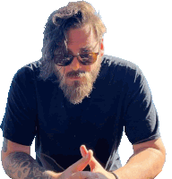 a man with a beard wearing sunglasses and a black shirt has a tattoo on his arm