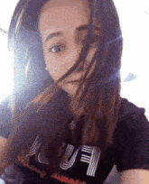 a woman wearing a black t-shirt that says " always " on it