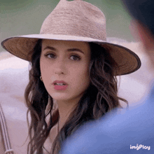 a woman wearing a straw hat has a watermark that says imgplay on the bottom right