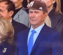 a man in a suit and tie is wearing a hat that says ' texas ' on it