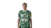a man wearing a green shirt with dkb 19 on it