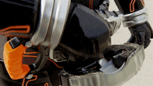 a close up of a person wearing a black and orange costume with the number 7 on it