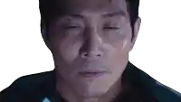 a close up of a man 's face with his eyes closed .